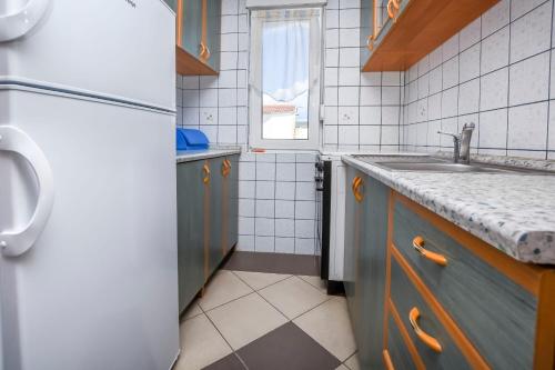 uma cozinha com um lavatório e um frigorífico em Apartments Sopic em Rogoznica