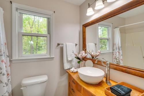 a bathroom with a sink and a mirror at North Carolina Retreat - Deck, Grills and Lake Views in High Point