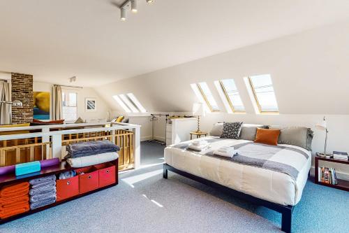 a bedroom with a bed and some windows at Sheepscot River Perch in Wiscasset