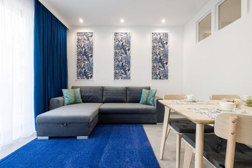 a living room with a couch and a table at Polanka Apartamenty in Niechorze