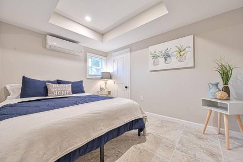 a bedroom with a bed with a blue comforter at 653 3rd St unit1 AfterDune Delight 2BR Near Beach in Somers Point