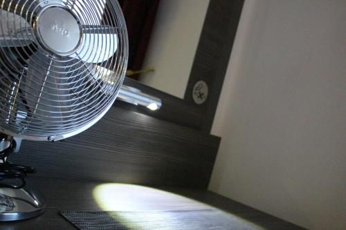 a fan sitting on top of a wooden table at Rheinhotel Lilie in Boppard