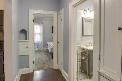 a white bathroom with a sink and a mirror at Milwaukee Vacation Rental - 2 Mi to Dineen Park! in Milwaukee