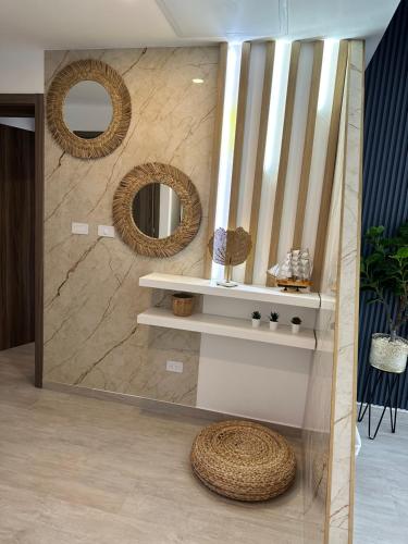a bathroom with a mirror and a shelf and a sink at LUXURY CONDO Cana Bay 1 CLUB BEACH in Punta Cana