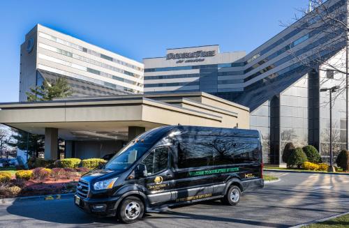 a blue bus parked in front of a building at DoubleTree by Hilton Hotel Newark Airport in Newark