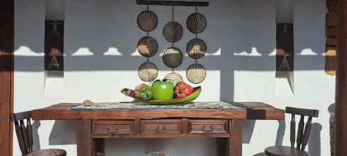 a table with a bowl of fruit on top of it at Casa Tierrarte in Barichara