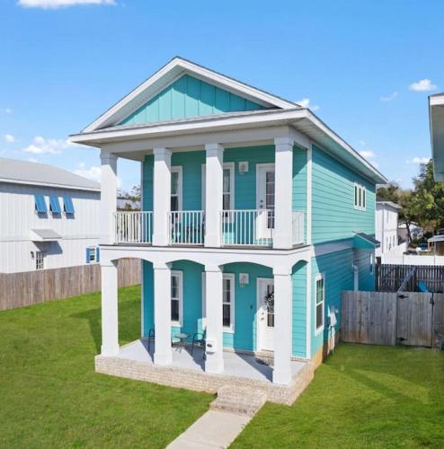 a blue and white house with a balcony at Walk to downtown seafood market Bay views in Pensacola