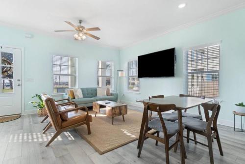 a living room with a table and a couch at Walk to downtown seafood market Bay views in Pensacola