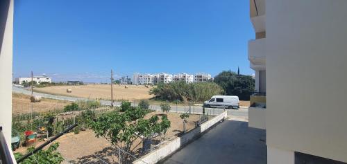 a view from a balcony of a street with a van at STEFARIS PROPERTIES 'sioukris court' in Larnaka