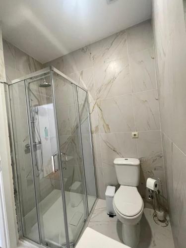 a bathroom with a shower and a toilet at Centro da Vila in Ponte de Lima