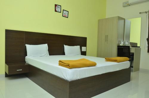 A bed or beds in a room at THE SURRYA MAX RESIDENCY