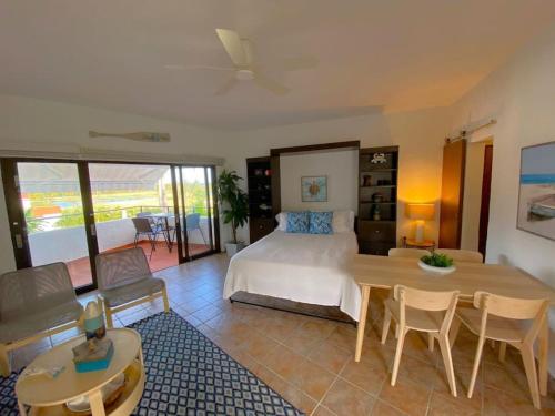 a bedroom with a bed and a table and chairs at KASA Rio Mar Villa for 2 in Rio Grande