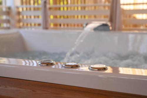 a row of five gold rings on a bath tub at Camping Resort Tina Vrsar in Vrsar