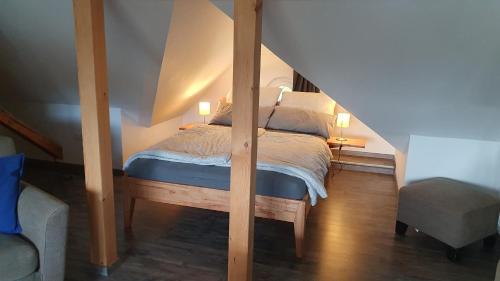 a bedroom with a bed with two lamps on it at Ferienwohnung Schulz in Dresden