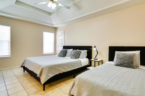 a bedroom with two beds and a ceiling fan at Lovely Mission Apartment in Prime Location! in Mission