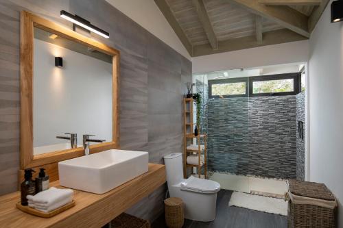 a bathroom with a white sink and a shower at Villa Mar y Lago, Casa de Campo in La Romana
