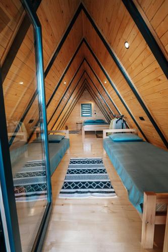 a room with three beds in a attic at Lake House Beliz in Livno