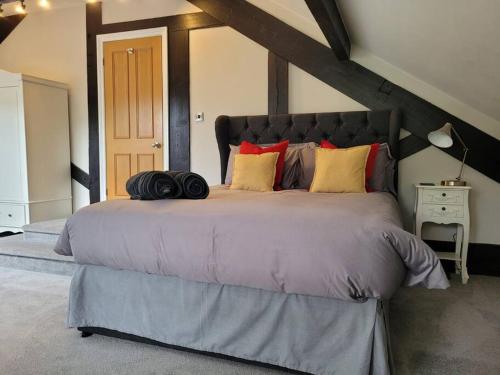 a bedroom with a large bed in a attic at Luxury Penthouse on Waterside Knaresborough in Knaresborough