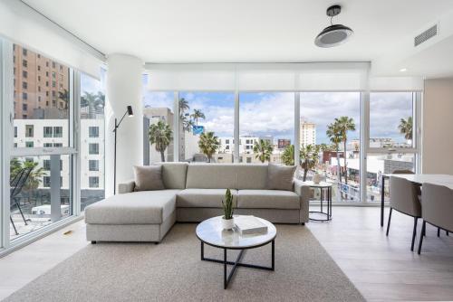 a living room with a couch and a table at Level Long Beach - East Village in Long Beach