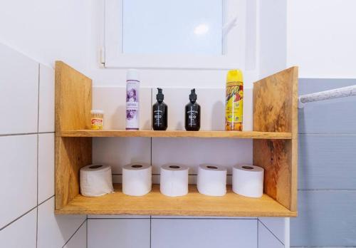 a wooden shelf with toilet paper and bottles on it at B10-02 Studio, Apt 23, Mwangani Apartments in Fumba
