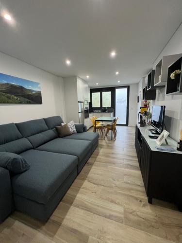 a living room with a couch and a table at Casa da Margarida in Vila Nova de Foz Coa