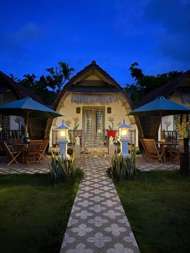 a house with a pathway leading to it with umbrellas at Penida Hills in Nusa Penida