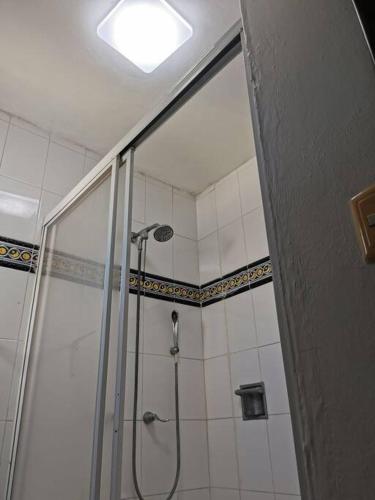 a shower with a glass door in a bathroom at Isla Mujeres departamento, hasta para 6 personas. in Isla Mujeres
