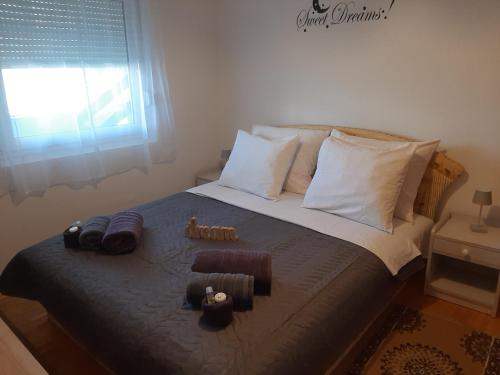 - une chambre avec un lit doté d'oreillers et d'une fenêtre dans l'établissement Apartman Posavac, à Crikvenica