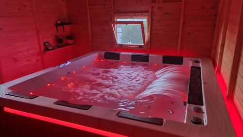 - un bain à remous dans une chambre avec des lumières rouges dans l'établissement Mare Nostrum Santo, à Oia