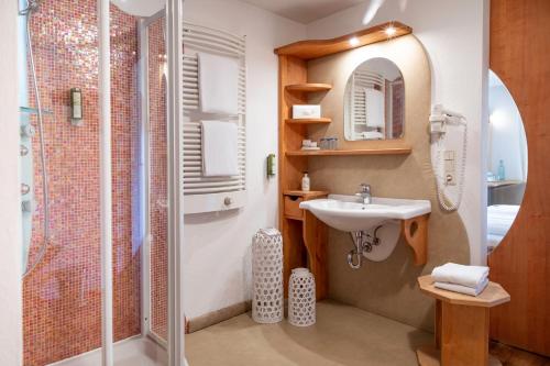 a bathroom with a sink and a shower at Hotel & Gasthaus Dresch in Erl