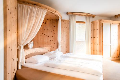 a bedroom with a bed with a canopy at Hotel & Gasthaus Dresch in Erl