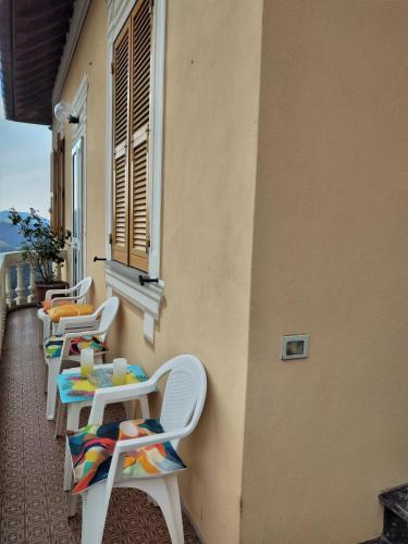 a row of chairs and tables on the side of a building at CasarinoLaurino Among Cinque Terre Genova And Portofino in Uscio