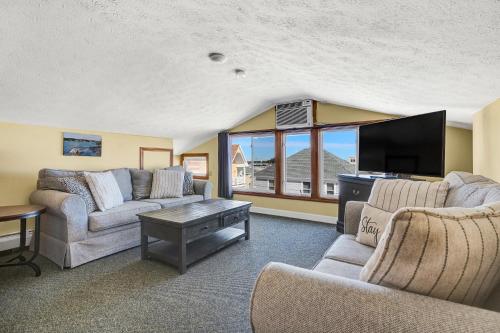sala de estar con 2 sofás y TV de pantalla plana en Abellona Inn & Suites en Old Orchard Beach