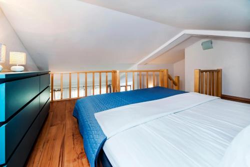 a bedroom with a large bed and a wooden floor at Apartments Vanda Rovinj in Rovinj