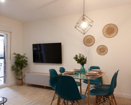 een eetkamer met een tafel, stoelen en een tv bij Apartamento Premium Ávila PLAZA MAYOR con PARKING in Avila