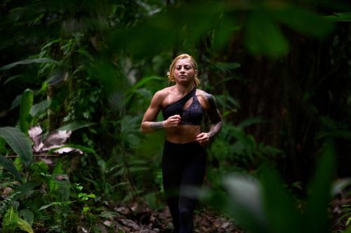 a woman running on a trail in the forest at Manzanillo Caribbean Resort in Puerto Viejo
