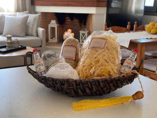 a basket filled with bottles and pasta and drinks at Horizon Villa Mani - Seaview Family Friendly House in Stoupa