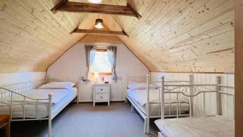 a bedroom with two bunk beds in a attic at Chata Jedovnice in Jedovnice