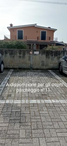 a house with a car parked in a parking lot at Da Vinci House in Fiumicino