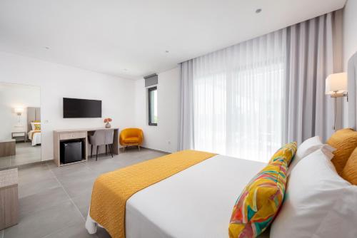a hotel room with a bed and a television at Vila Luna B&B in Lagos