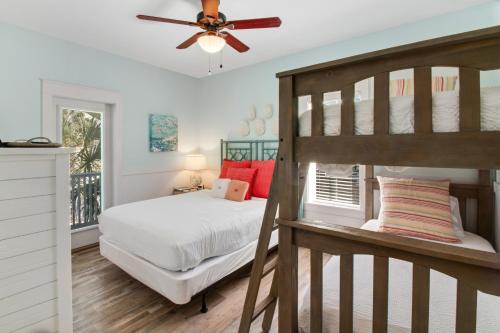 a bedroom with a bunk bed and a ceiling fan at Bungalows at Seagrove 135 - MerSea in Seagrove Beach