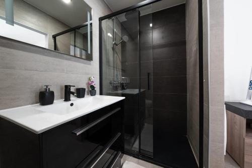 a bathroom with a white sink and a shower at Luxury Apartment near Cascais Town & Marina in Cascais