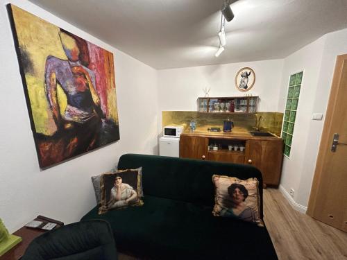 a living room with a green couch and a kitchen at Willa 1936 , Parking in Toruń