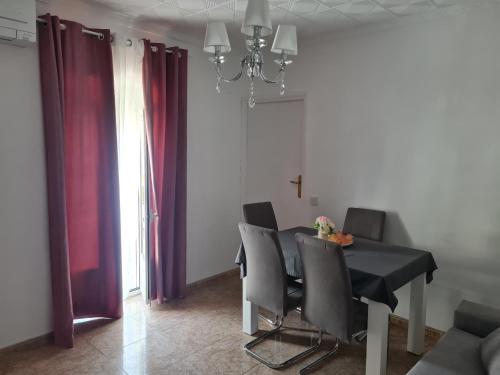 a dining room with a black table and chairs at La encantá in Almodóvar del Río