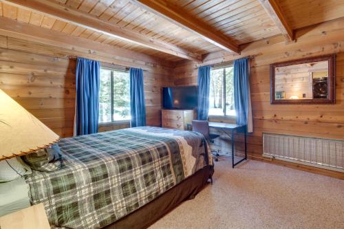 a bedroom in a log cabin with a bed and a desk at One Moose Lodge with Hot Tub in Tahoe Donner in Truckee