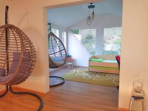 a room with two hanging chairs and a bedroom at Villa Kalina in Ohrid