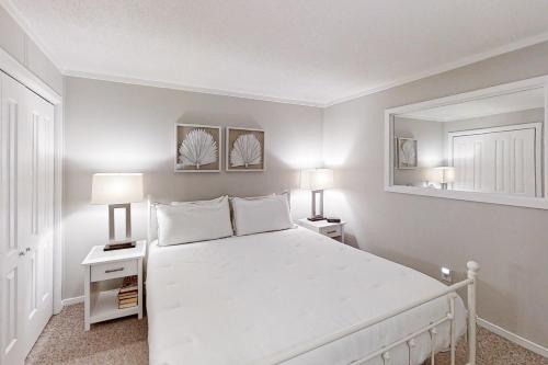 a bedroom with a large white bed and two lamps at Myrtle Beach Resort A-326 in Myrtle Beach