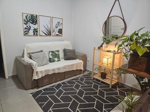 a living room with a chair and a mirror at CASA_ESTRELA in Angra dos Reis