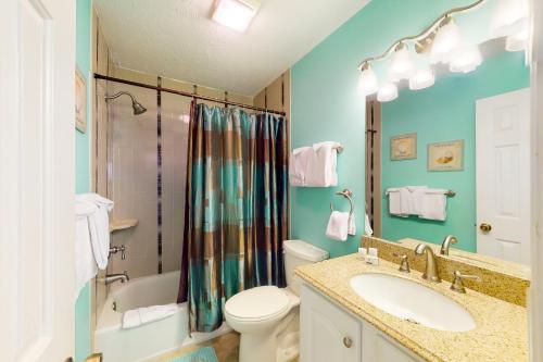 a bathroom with a sink and a toilet and a shower at Pinehurst X-6 in Little River