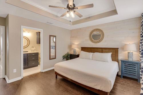 a bedroom with a bed and a ceiling fan at Palm Tree Paradise in Padre Island